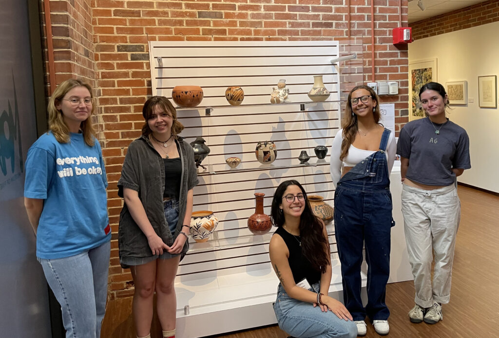 Art History Museum Object students with exhibition display at the FSU Museum of Fine Arts