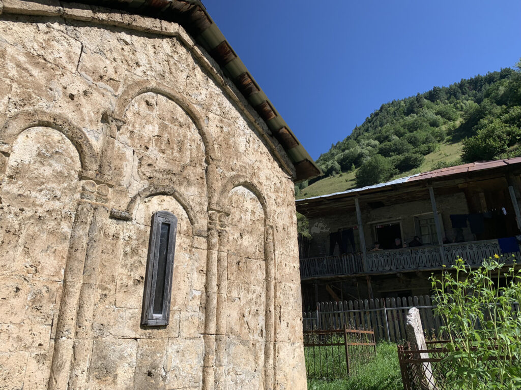 there is a stone building with a small window on the side of it