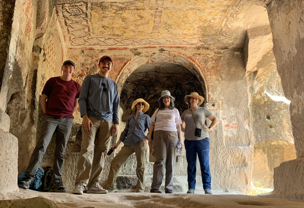 there is a group of people that are standing together in a cave