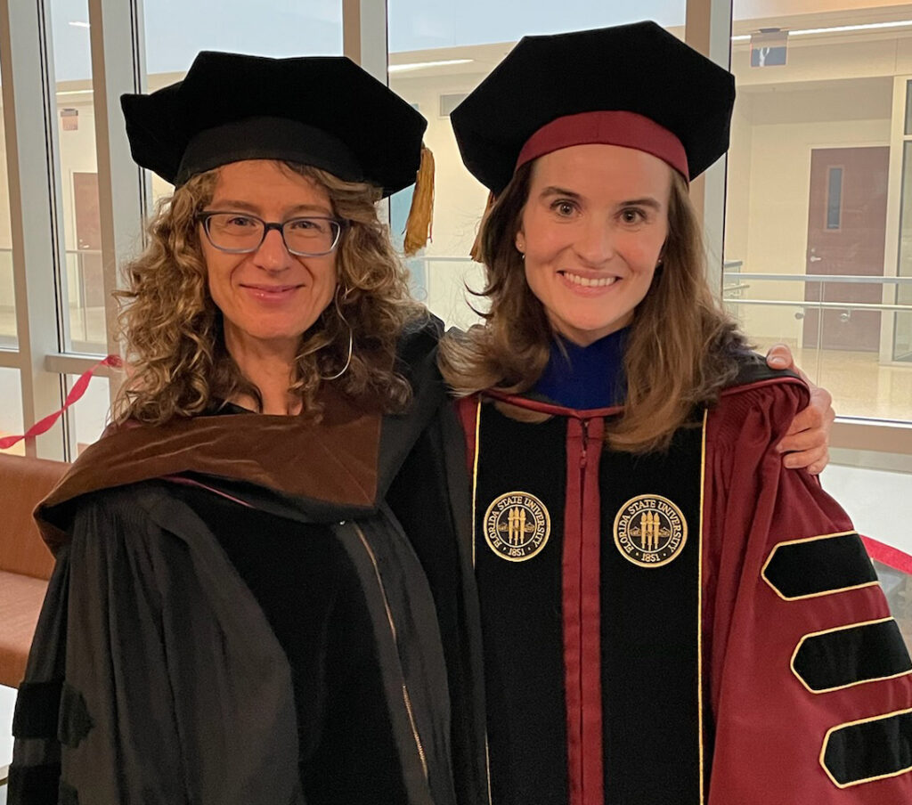 there are two women standing next to each other in graduation gowns