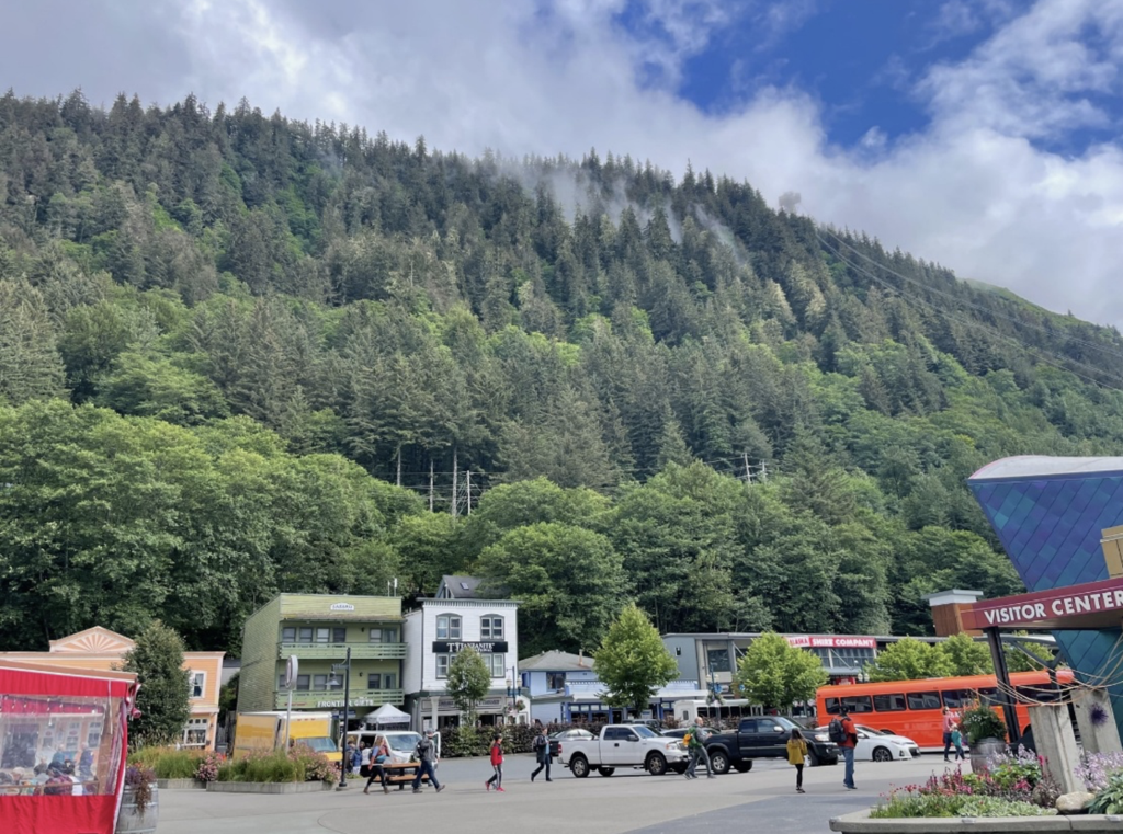 cars are parked in a parking lot with a mountain in the background