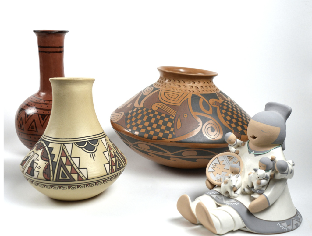 there are three vases that are sitting next to each other on a table