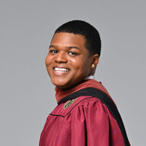 there is a woman in a graduation gown posing for a picture