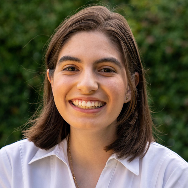 there is a woman that is smiling and wearing a white shirt