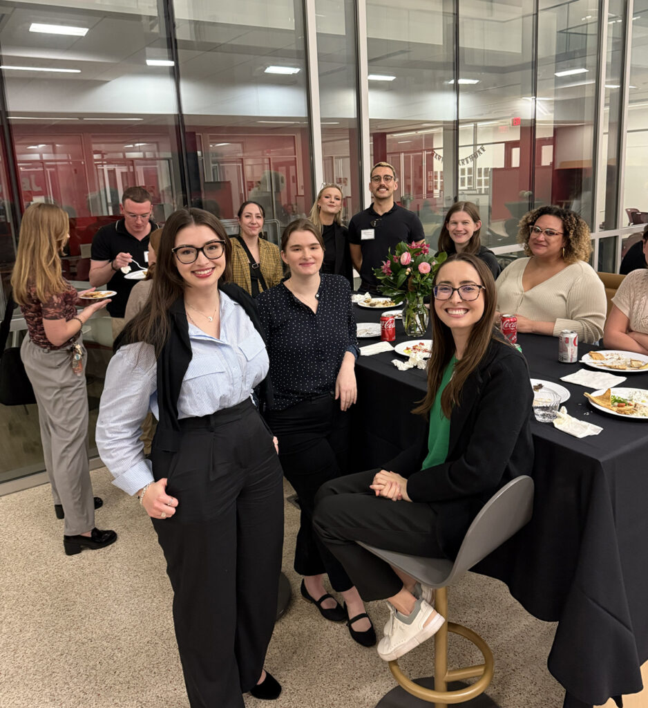 there are a group of women sitting at a table with plates of food