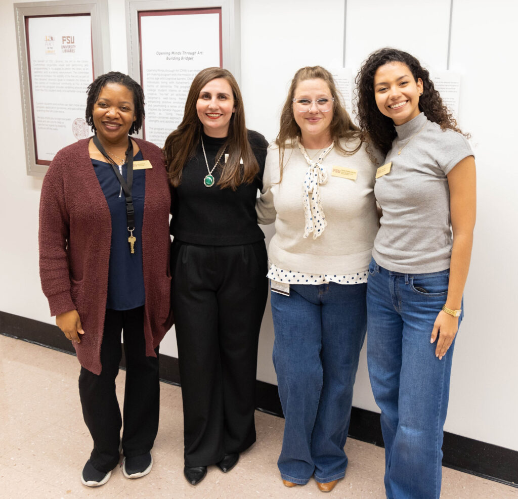 there are three women standing next to each other in front of a wall