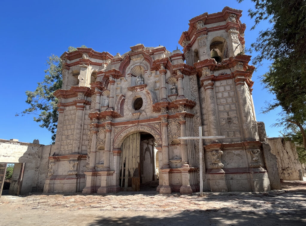 this is an old church with a cross in front of it