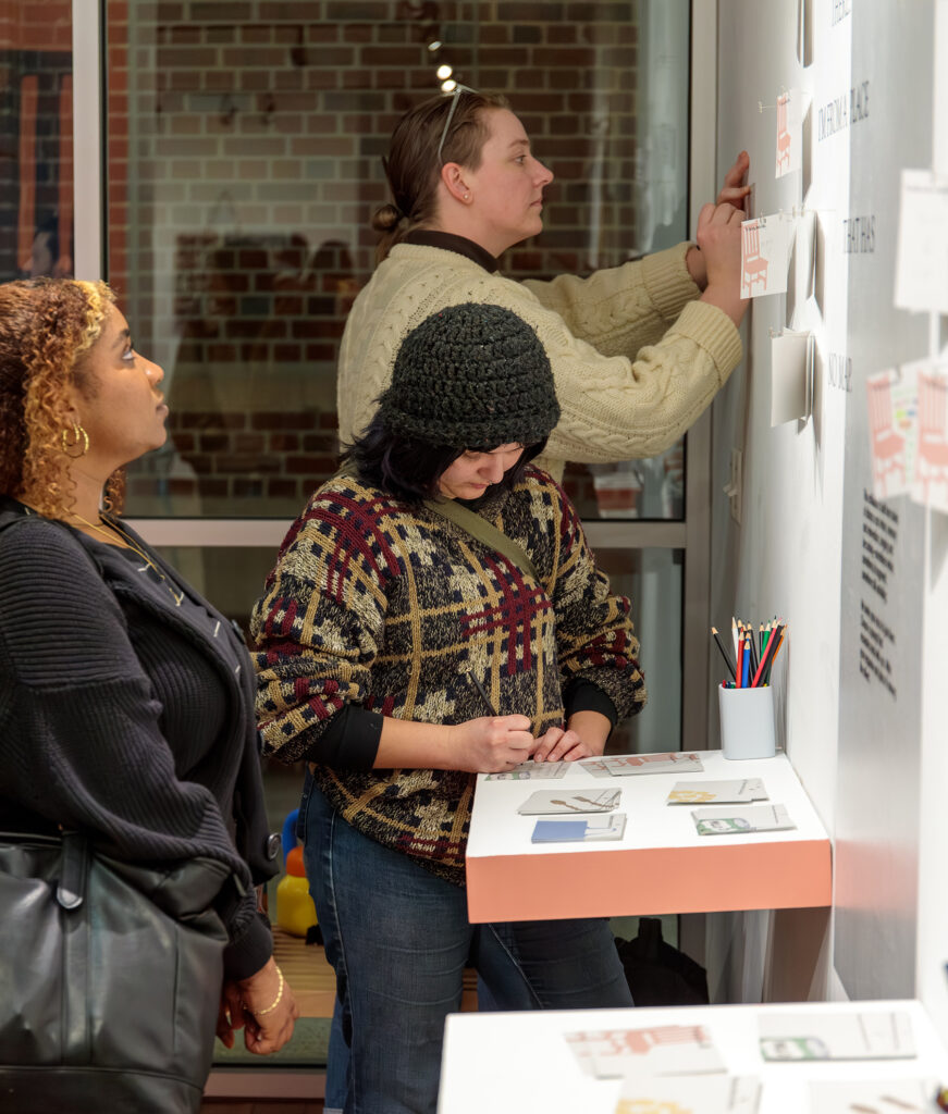 there are two women that are standing in front of a white board