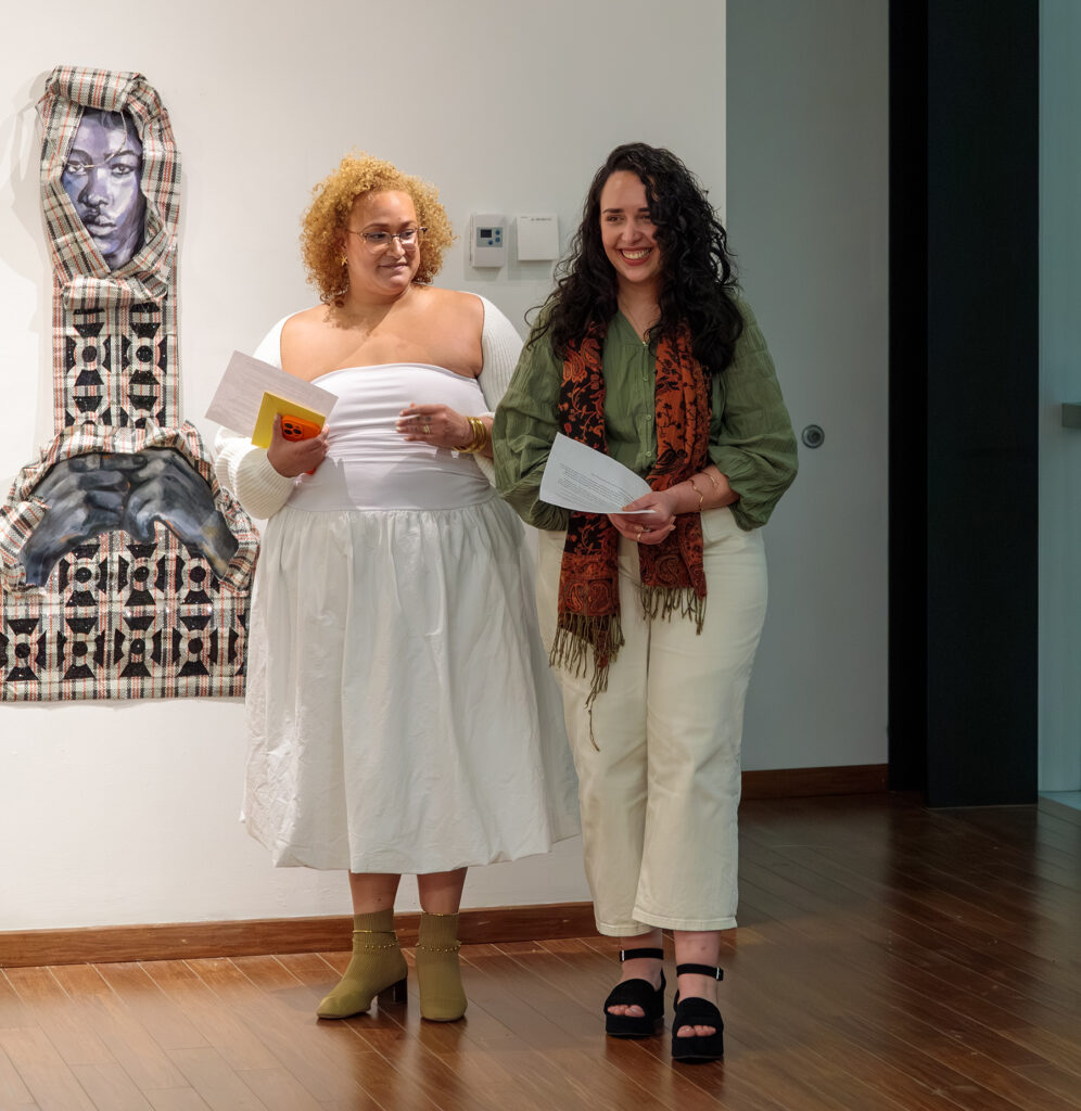 there are two women standing next to each other in a room