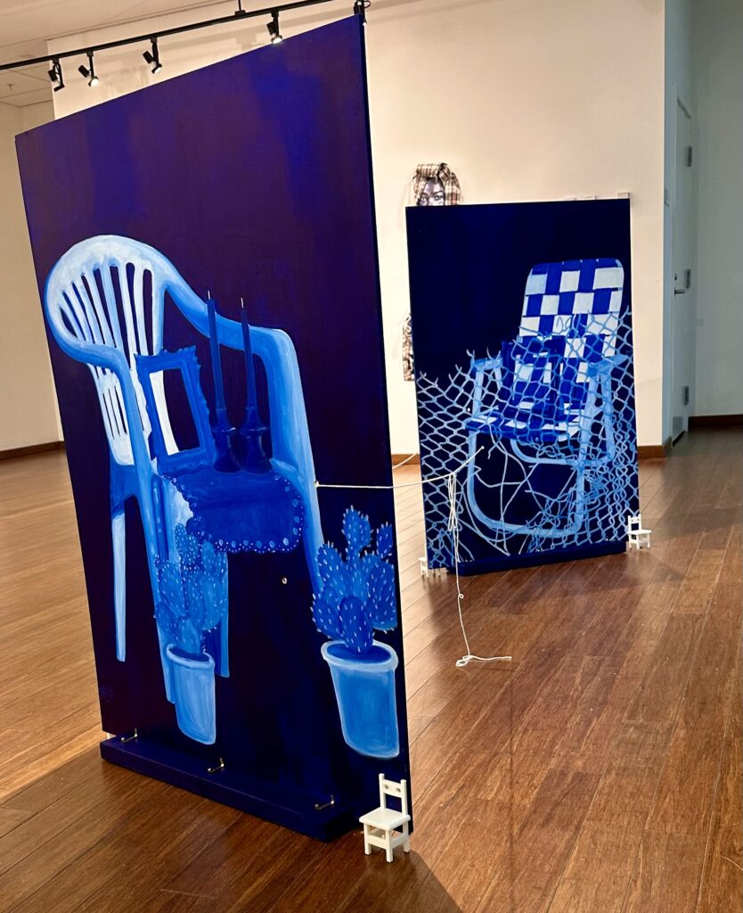 painting of a blue chair and a blue chair in a room with wood floors