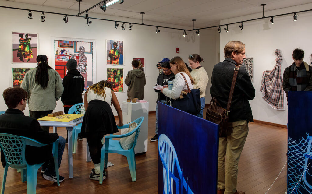 there are many people standing and sitting at tables in a room