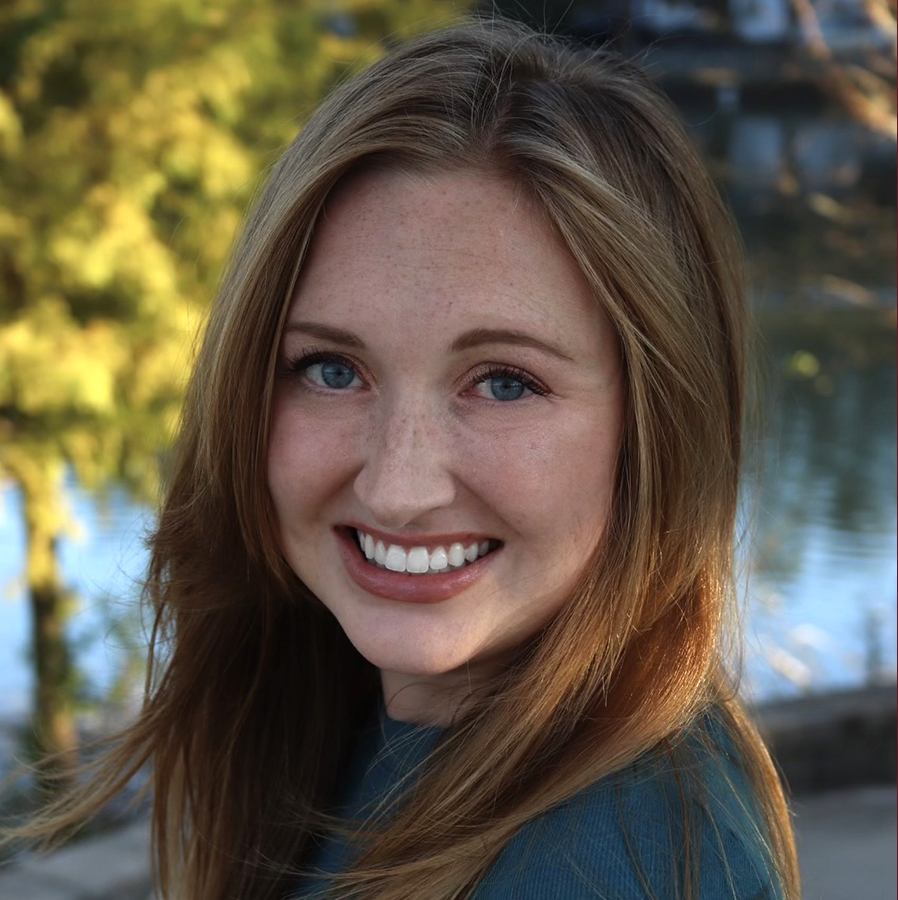 there is a woman that is smiling and posing for a picture