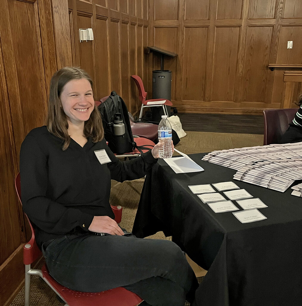 there is a woman sitting at a table with cards on it