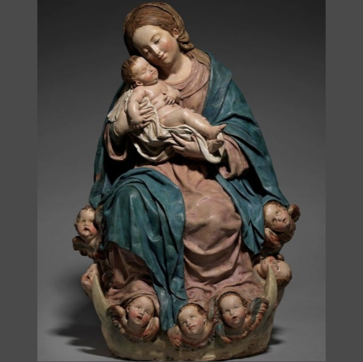 an image of a statue of a woman holding a baby