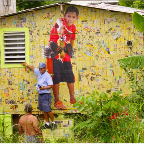 there are two men standing in front of a building with a picture on it