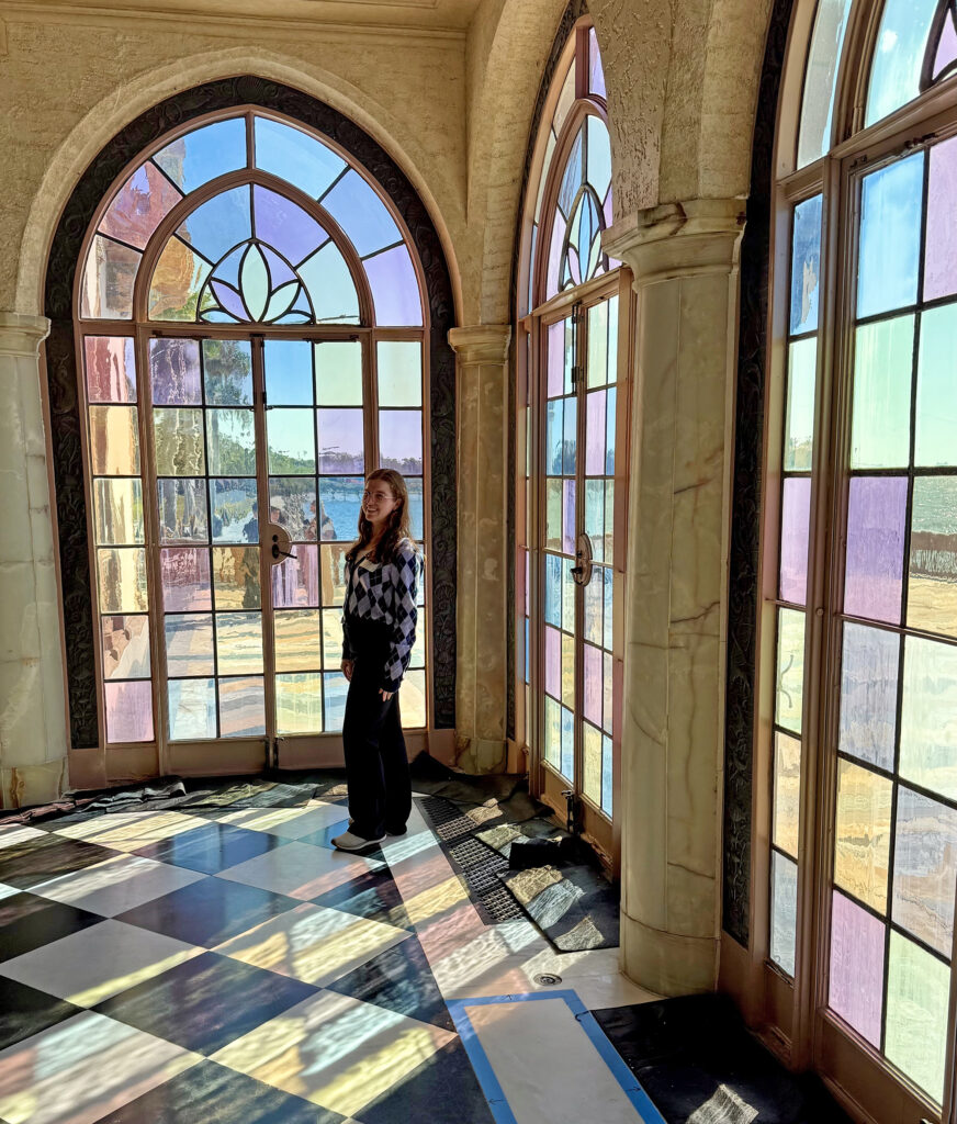 there is a woman that is standing in front of a window