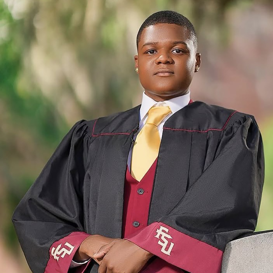 there is a young man in a graduation gown posing for a picture