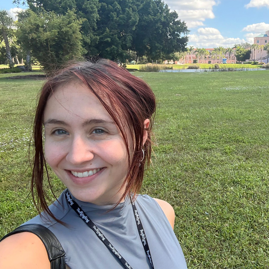 there is a woman that is taking a selfie in the park