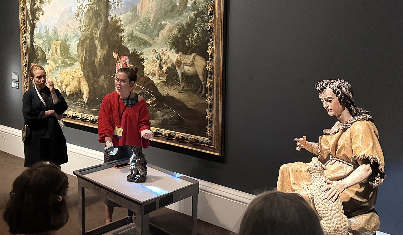 there is a man and a woman standing in front of a painting