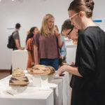 Students looking at Interwoven exhibition